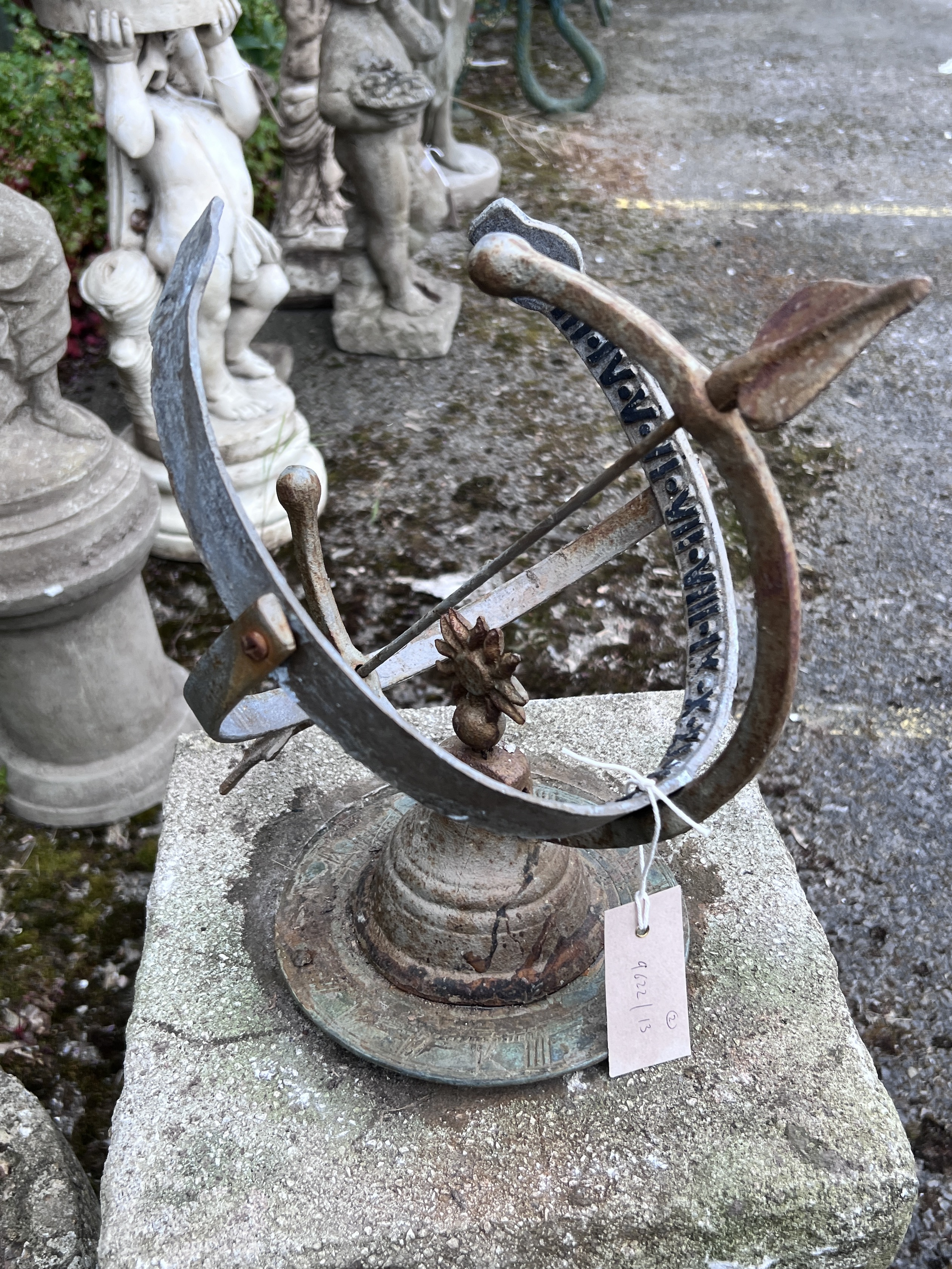 A sphere sundial on reconstituted stone plinth, height 85cm, and a smaller shell shaped bird bath